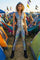 woman at a festival wearing a silver hooded zipper catsuit from Love Khaos