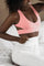 Pink lounge bra with white joggers made from eco friendly recycled plastic fabric by Ekoluxe sustainable loungewear brand 