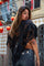 woman wearing a suede fringe poncho from Love Khaos.